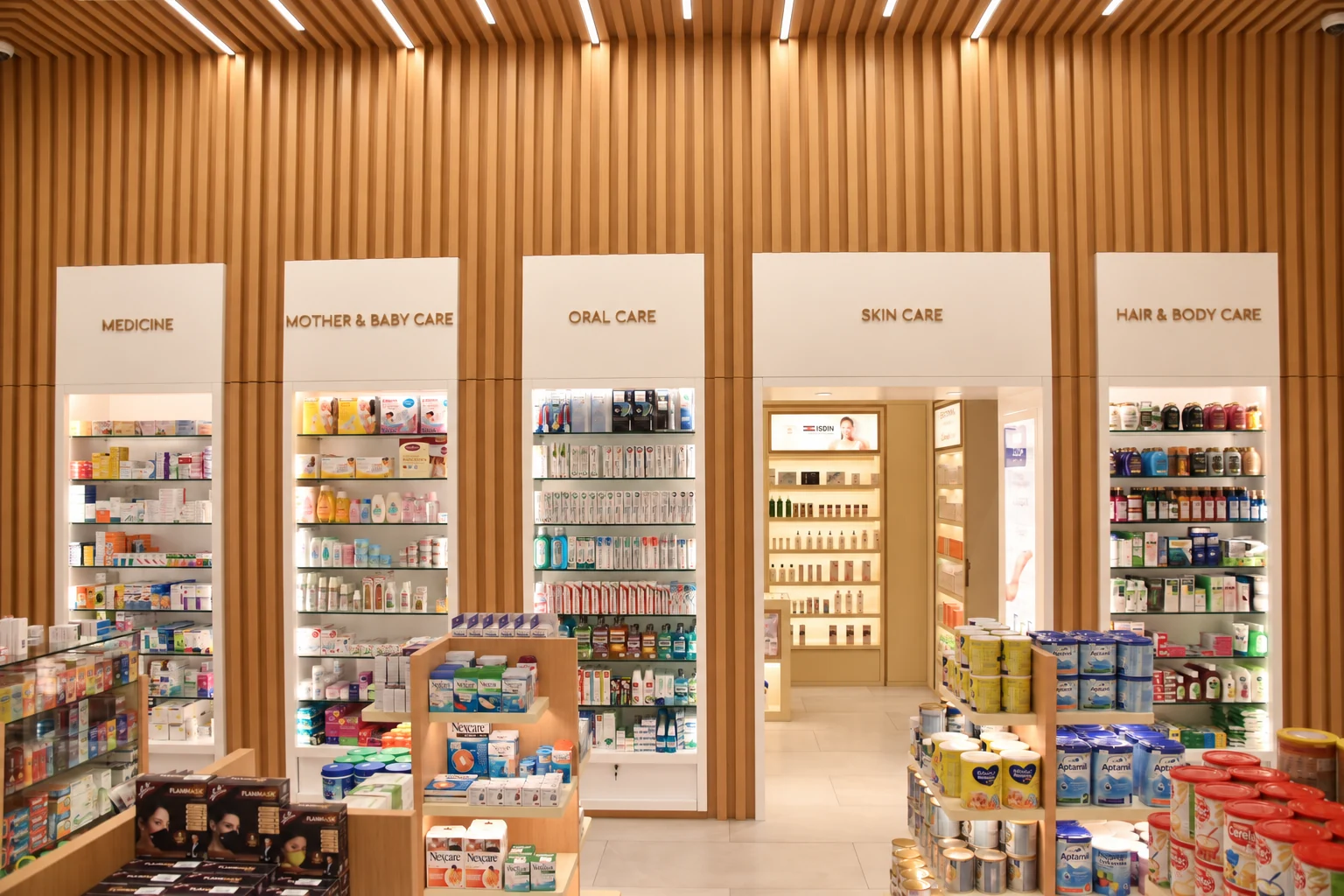 Timber slat wall and illuminated retail display cabinets at Muscat Pharmacy