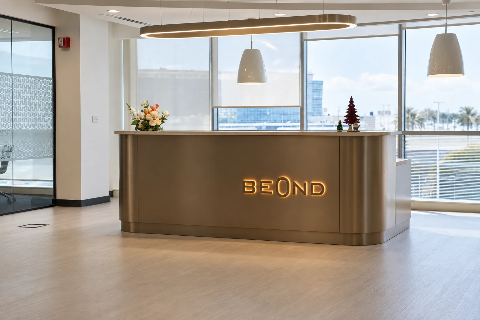 Curved bronze reception counter with illuminated Beond lettering and pendant lighting